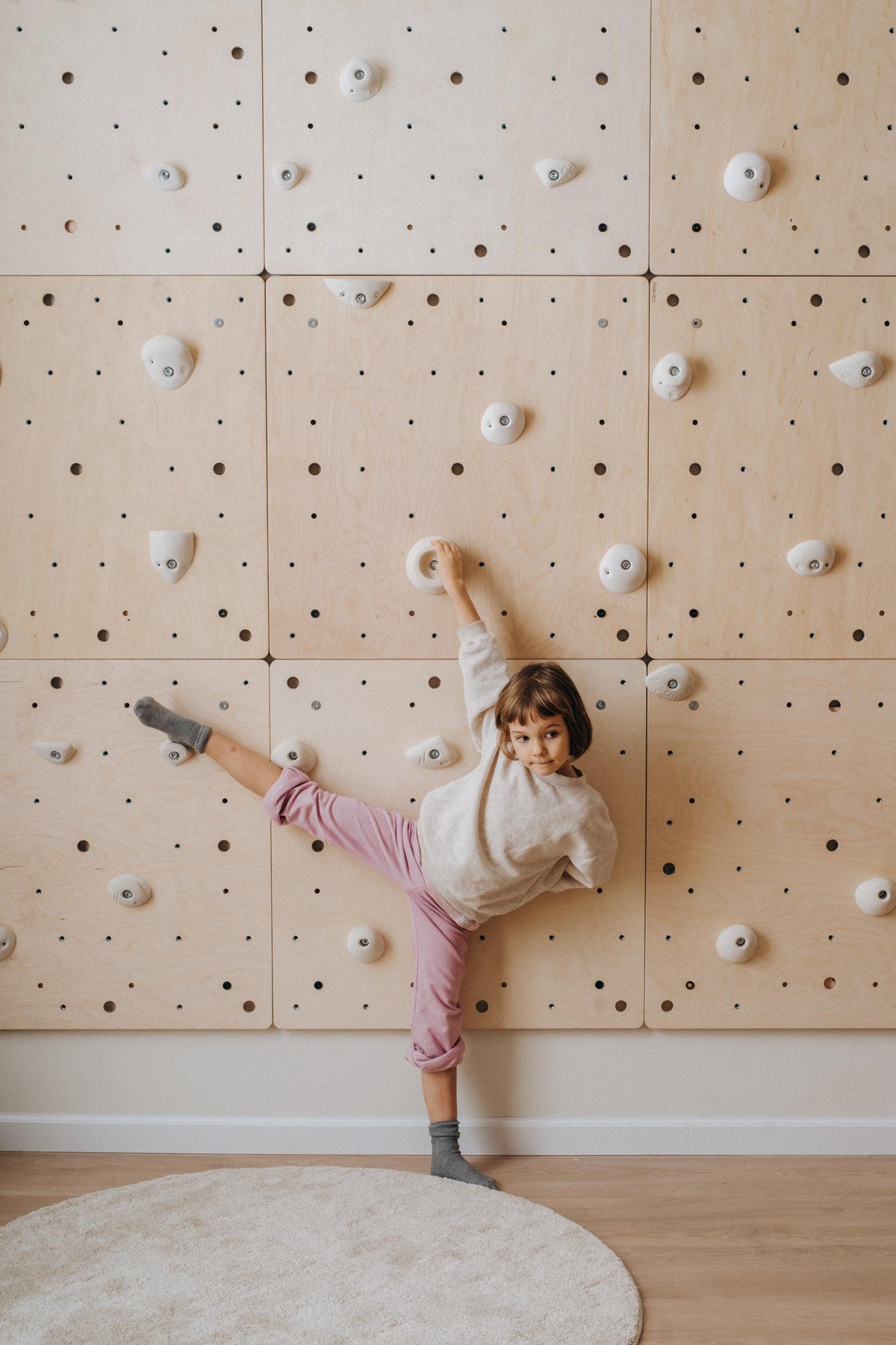 Modular indoor climbing wall with white holds