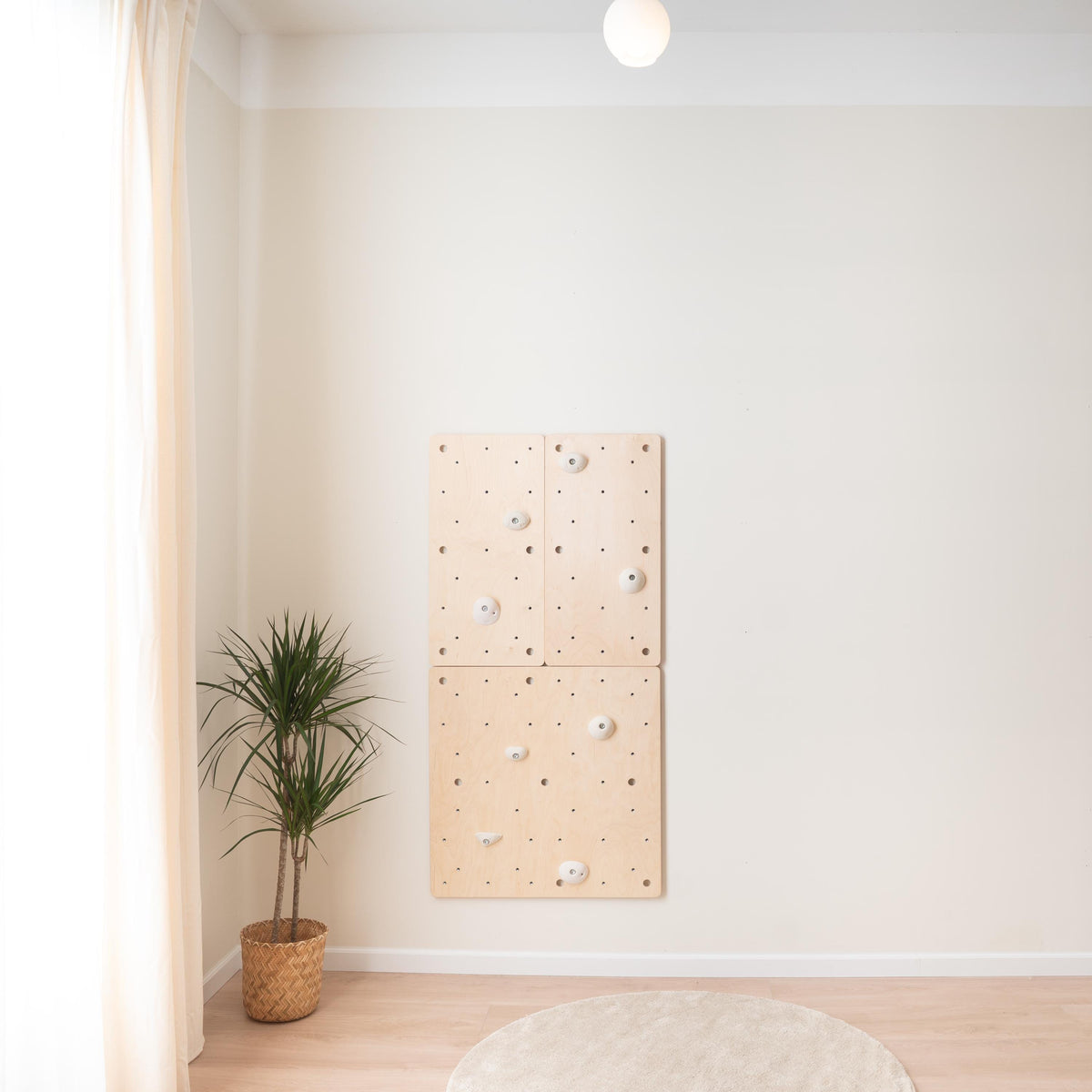 Climbsy wooden climbing wall made of four M size birch plywood panels with white holds