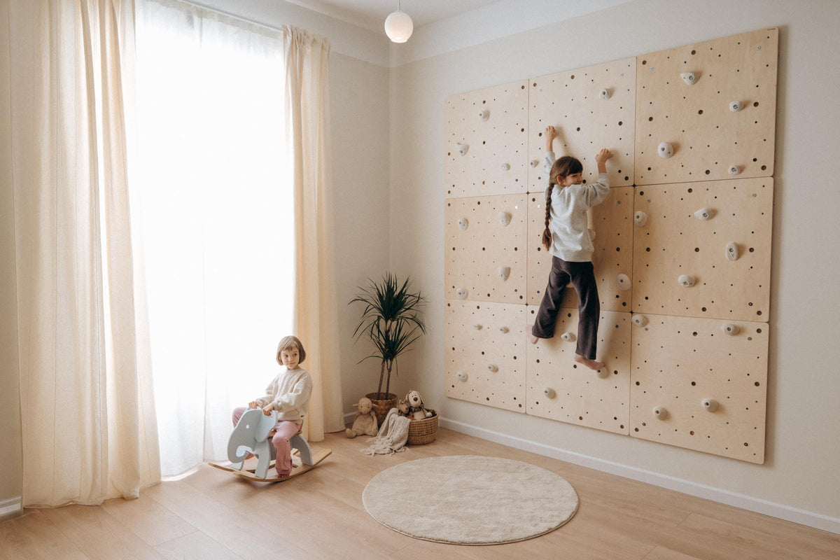 Child climbing a Climbsy wall made of nine L size panels