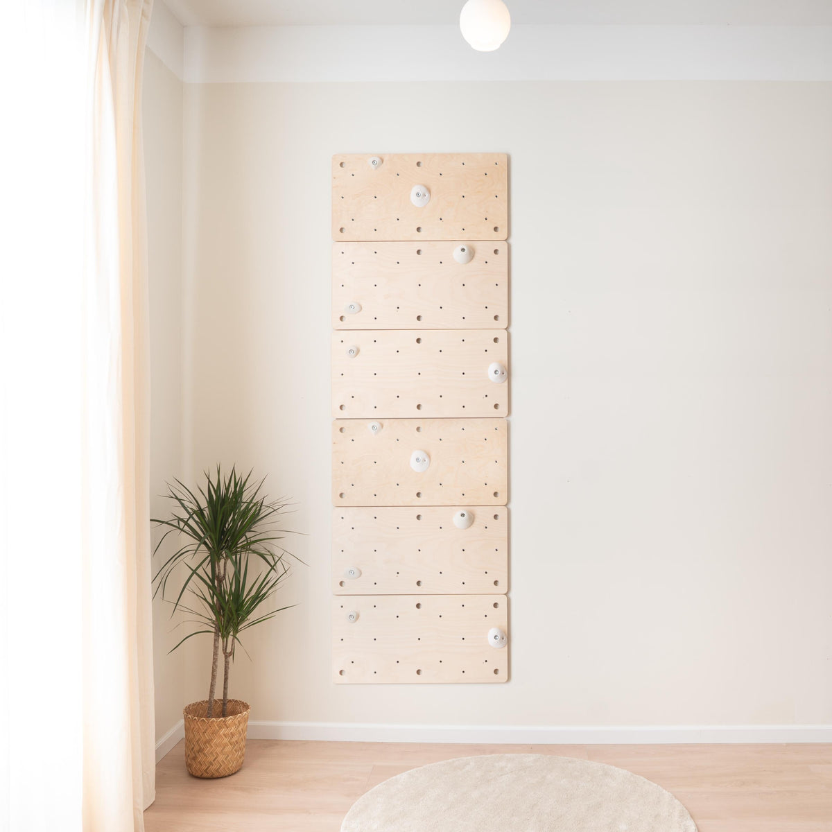Six-panel Climbsy climbing board on a wall