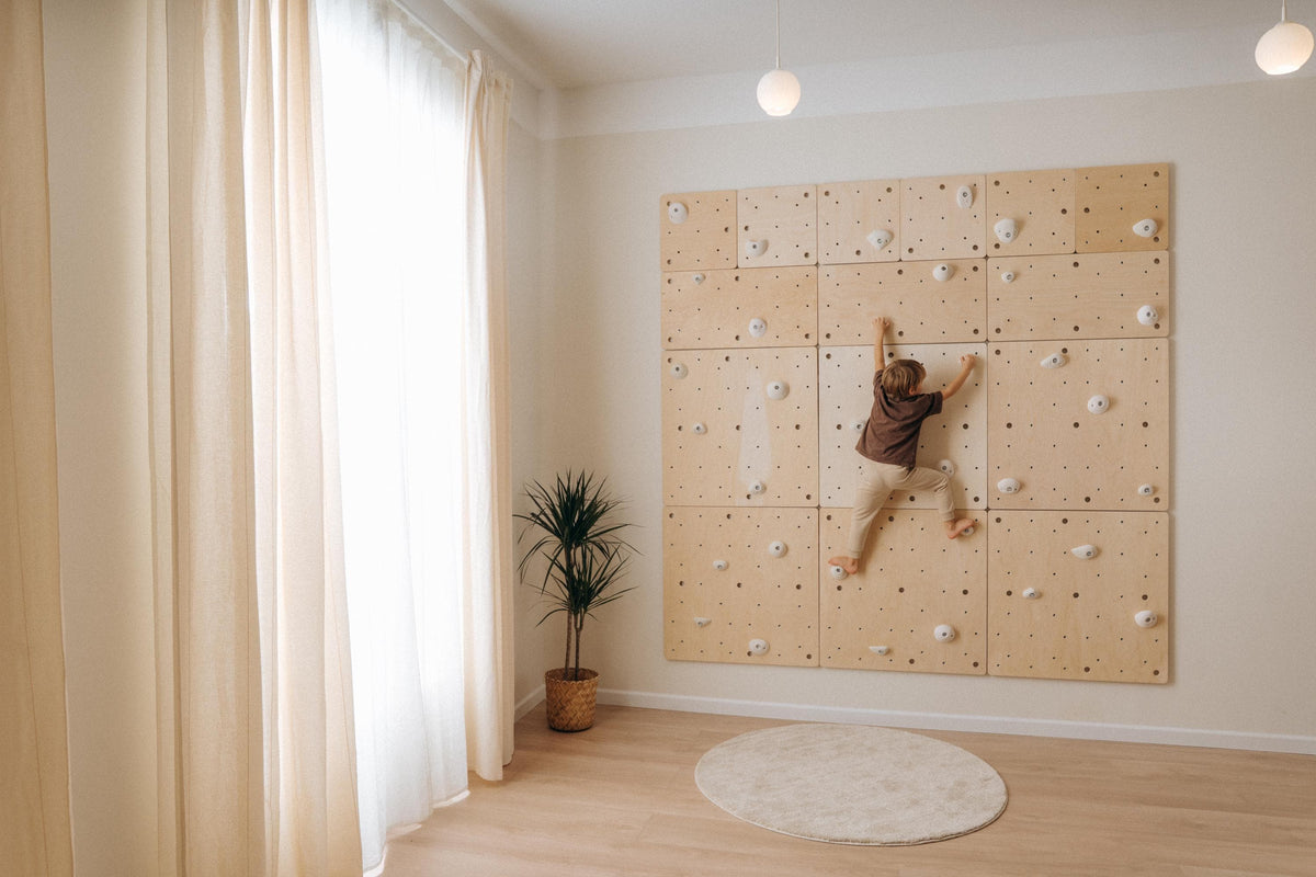 Toddler climbing gym made of Climbsy wooden wall panels with white holds
